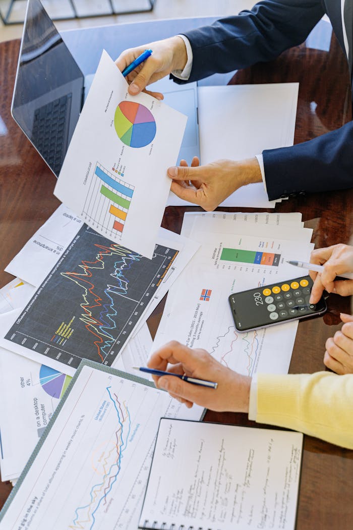 about-02 Business professionals analyzing financial charts and graphs during a meeting.